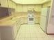 Functional kitchen featuring white appliances, ample cabinet space, and an efficient layout at 11263 Murraysville Dr, Spring Hill, FL 34609