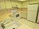 Clean kitchen with white cabinets, countertops, sink, and appliances offering functionality and space at 11263 Murraysville Dr, Spring Hill, FL 34609