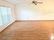 Bright living room with hardwood floors, a ceiling fan, and a large window at 11263 Murraysville Dr, Spring Hill, FL 34609