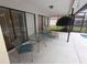 View of the screened in patio with furniture and view of the pool at 11263 Murraysville Dr, Spring Hill, FL 34609