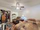 Bedroom with ceiling fan, comfy chair, closet, and cozy decor at 11622 White Ash Dr, New Port Richey, FL 34654