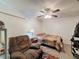 Bedroom features ceiling fan, cozy chair, and a comfortable bed at 11622 White Ash Dr, New Port Richey, FL 34654
