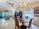 Inviting dining area with a glass-top table, chandelier, and an open view into the cozy living space at 11622 White Ash Dr, New Port Richey, FL 34654