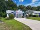 Charming single-story home with well-manicured lawn, decorative garage door, and inviting curb appeal at 11622 White Ash Dr, New Port Richey, FL 34654