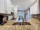 Close-up of the kitchen featuring granite countertops, stainless-steel sink, and modern appliances at 11622 White Ash Dr, New Port Richey, FL 34654