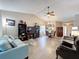 Spacious living area with vaulted ceilings, stylish furnishings, wood flooring, and an open layout at 11622 White Ash Dr, New Port Richey, FL 34654