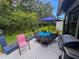 A cozy patio featuring an umbrella table and chairs, perfect for outdoor dining and relaxation at 11622 White Ash Dr, New Port Richey, FL 34654