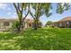 Spacious backyard with mature trees, offering privacy and a tranquil outdoor space at 11725 Spring Tree Ln, Port Richey, FL 34668