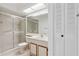 Bright bathroom featuring a shower, vanity, ample storage and a large, mirrored wall at 11725 Spring Tree Ln, Port Richey, FL 34668