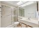 Well-lit bathroom featuring a vanity with ample counter space and a glass-enclosed shower at 11725 Spring Tree Ln, Port Richey, FL 34668