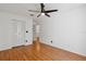 Inviting bedroom showcasing wood floors, a ceiling fan, and closet space at 11725 Spring Tree Ln, Port Richey, FL 34668
