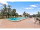 Large community pool with lounge chairs, umbrellas, and a nearby clubhouse for resident enjoyment at 11725 Spring Tree Ln, Port Richey, FL 34668