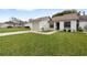 Well-maintained single-story home with a manicured lawn and one car garage in a quiet neighborhood at 11725 Spring Tree Ln, Port Richey, FL 34668