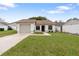 Charming single-story home featuring a well-manicured lawn and attached one car garage at 11725 Spring Tree Ln, Port Richey, FL 34668
