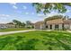 Exterior view of single-story home with lush green lawn and driveway in quiet neighborhood at 11725 Spring Tree Ln, Port Richey, FL 34668