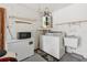 This garage features a washer, dryer, water heater, and extra freezer for added convenience at 11725 Spring Tree Ln, Port Richey, FL 34668