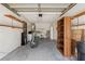 Spacious garage interior with a motorcycle, shelving, utilities, and storage at 11725 Spring Tree Ln, Port Richey, FL 34668