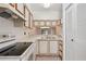 Functional kitchen featuring white cabinetry, stainless cooktop, and tile floor at 11725 Spring Tree Ln, Port Richey, FL 34668