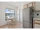 Eat in kitchen area with stainless refrigerator and breakfast nook at 11725 Spring Tree Ln, Port Richey, FL 34668