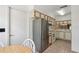 Eat in kitchen area with stainless refrigerator and white appliances at 11725 Spring Tree Ln, Port Richey, FL 34668