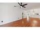 Bright living room featuring wood floors, a modern ceiling fan, and an open concept design at 11725 Spring Tree Ln, Port Richey, FL 34668