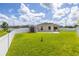 View of backyard with a storage shed, green grass, concrete patio, and white fence around perimeter at 12119 Barnsley Reserve Pl, Gibsonton, FL 33534