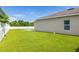 Expansive backyard showcasing lush green grass and a white fence for added privacy at 12119 Barnsley Reserve Pl, Gibsonton, FL 33534