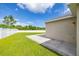 Large backyard with a lush green lawn, concrete patio, and a white fence providing privacy at 12119 Barnsley Reserve Pl, Gibsonton, FL 33534