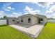 Backyard featuring a well-maintained lawn, storage shed, and a concrete patio perfect for outdoor entertaining at 12119 Barnsley Reserve Pl, Gibsonton, FL 33534