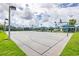 Community basketball court with well-maintained surface, hoops, and lighting at 12119 Barnsley Reserve Pl, Gibsonton, FL 33534