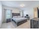The main bedroom features tile flooring, a ceiling fan, and a full-sized bed at 12119 Barnsley Reserve Pl, Gibsonton, FL 33534