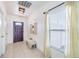 Bright entryway with tile floors, decorative hats, and a comfortable bench at 12119 Barnsley Reserve Pl, Gibsonton, FL 33534