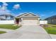 Charming single-story home with a well-maintained lawn and a two-car garage at 12119 Barnsley Reserve Pl, Gibsonton, FL 33534