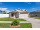 Inviting single-story home with neat landscaping and a spacious driveway at 12119 Barnsley Reserve Pl, Gibsonton, FL 33534