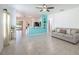 Open-concept living room with tile floors and a partial view of the kitchen at 12119 Barnsley Reserve Pl, Gibsonton, FL 33534