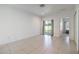 A light-filled living room features sliding glass doors that lead to the fenced yard at 12119 Barnsley Reserve Pl, Gibsonton, FL 33534