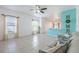 Comfortable living room featuring tile floors, natural light, and a view of the kitchen at 12119 Barnsley Reserve Pl, Gibsonton, FL 33534