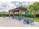 Outdoor patio area with wood pergola, lounge chairs and table with chairs at 12119 Barnsley Reserve Pl, Gibsonton, FL 33534