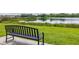 A park bench overlooking a tranquil pond surrounded by lush greenery at 12119 Barnsley Reserve Pl, Gibsonton, FL 33534