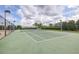 A well-maintained community tennis court with net and surrounding fence at 12119 Barnsley Reserve Pl, Gibsonton, FL 33534