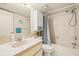 Cozy bathroom features a tub with shower and vanity with neutral countertops and coordinated cabinets at 12141 Spartan Way # 102, Hudson, FL 34667