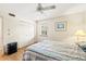 Bedroom featuring light wood flooring, ceiling fan, and double closet doors at 12141 Spartan Way # 102, Hudson, FL 34667