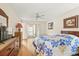Comfortable bedroom with wood-look flooring, TV, and dresser for ample storage at 12141 Spartan Way # 102, Hudson, FL 34667