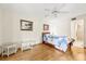 Comfortable bedroom with wood flooring, ceiling fan, and beach-inspired decor at 12141 Spartan Way # 102, Hudson, FL 34667