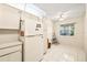 Bright kitchen nook featuring a window, white tile flooring, and lots of natural light at 12141 Spartan Way # 102, Hudson, FL 34667