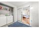 Handy laundry area with washer, dryer, storage shelving, and easy access to bedroom at 12141 Spartan Way # 102, Hudson, FL 34667