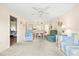 Open living area flows into the dining area with coordinated furnishings and decor at 12141 Spartan Way # 102, Hudson, FL 34667