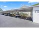Designated covered parking spaces at 12141 Spartan Way with parked cars and unit numbers displayed at 12141 Spartan Way # 102, Hudson, FL 34667