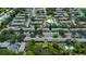Aerial view of a residential community with lush landscaping, multiple pools, and ample parking at 13651 Forest Lake Dr, Largo, FL 33771