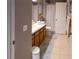 Neutrally-toned bathroom featuring a sink with wood cabinets and tile floors at 13651 Forest Lake Dr, Largo, FL 33771